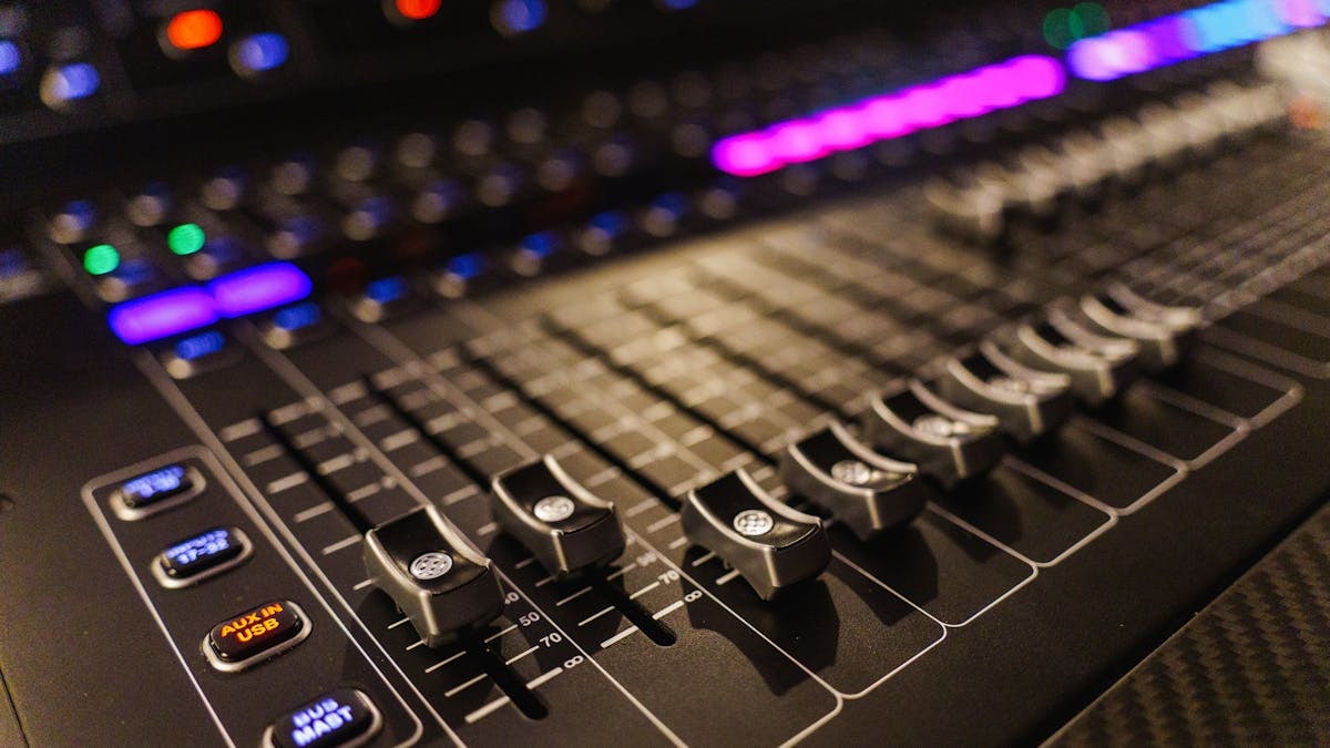 Detailed view of an advanced audio mixing console, perfect for studios.